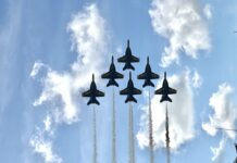 Troop 1777 Visited the Blue Angels Air Show in Virginia Beach Six Blue Angels jets flying in formation with smoke trails against a blue sky.